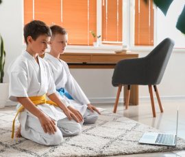 Little boys studying karate online at home
