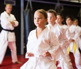 Girl practicing new moves during karate class